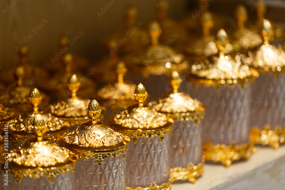 Openwork festive golden vase on a table is the background selective focus and shallow depth of field. Close up Openwork festive golden vase on a table is the background selective focus and shallow depth of field. Close up