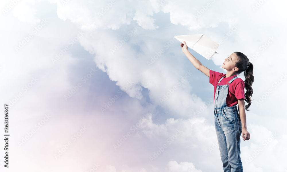 Concept of careless happy childhood with girl dreaming to become pilot Concept of careless happy childhood with girl dreaming to become pilot