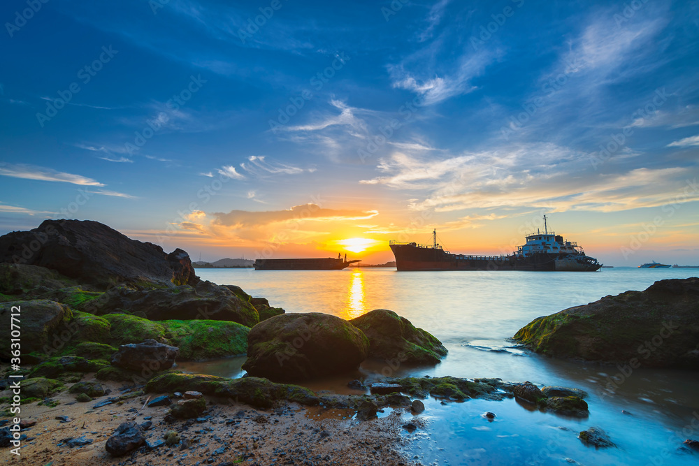 Tangker and barge in sunset on beach Batam island