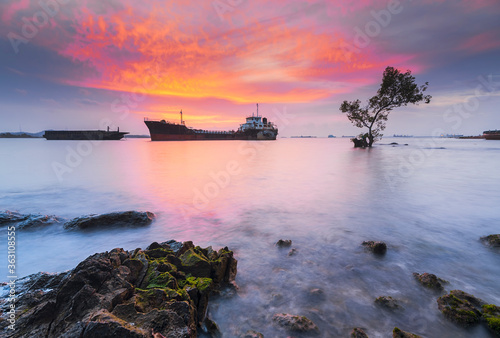 Tangker and barge in sunset on beach Batam island photo