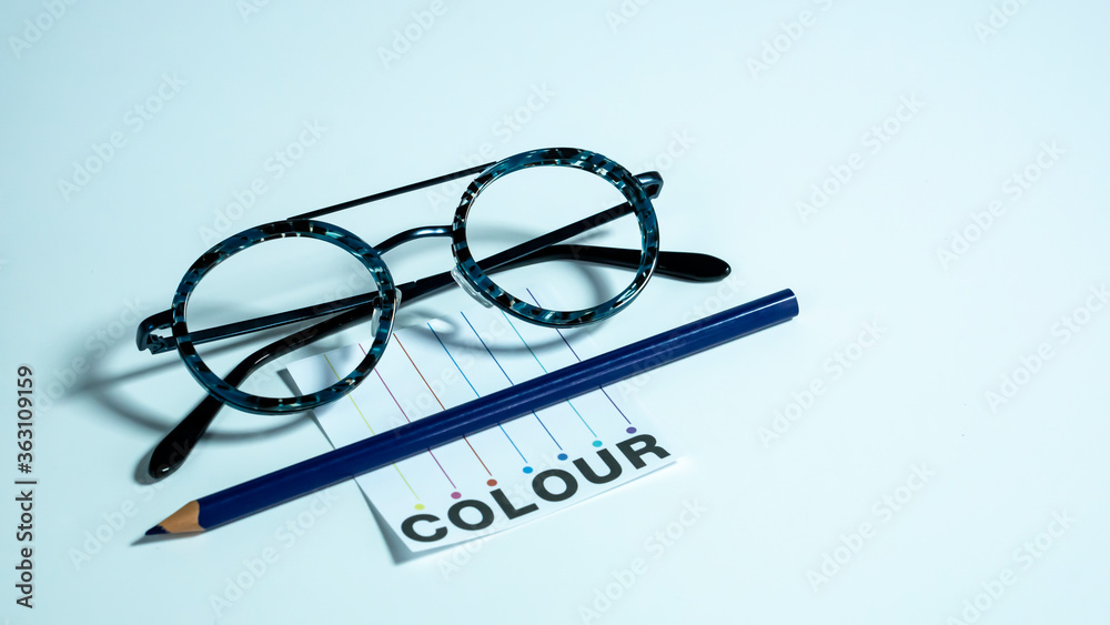 Colouful teenage eyeglasses with pencil and note paper Colouful teenage eyeglasses with pencil and note paper