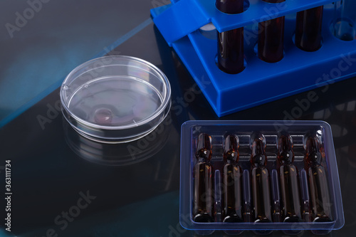 laboratory blood tests and the creation of an untested vaccine, a concept on a dark background photo