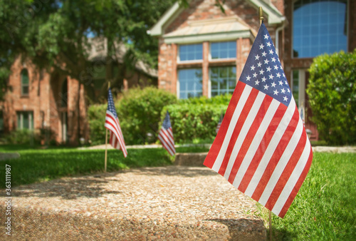Fotografie American flags displayed in the front of a southern home in honor of the 4th of