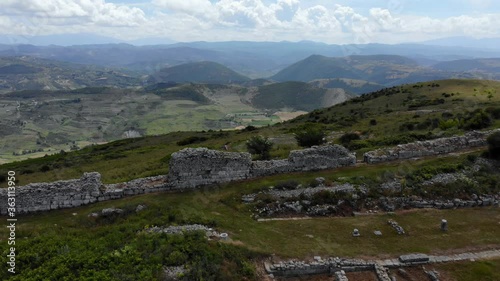 Stone walls of ruined buildings inside archaeological site of Bylis in Albania photo