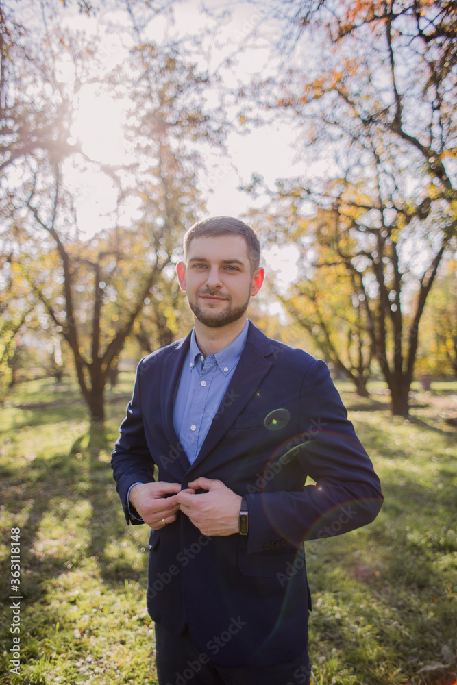 man in a suit in the autumn in the park