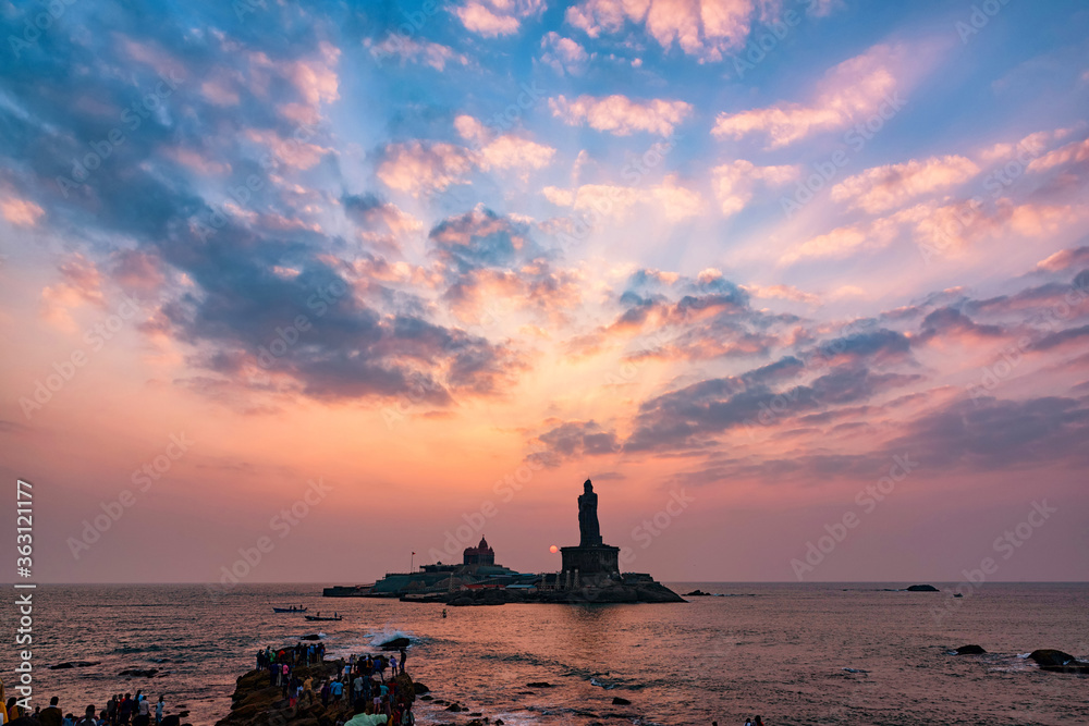 Unidentified tourists take a sunset view of Swami Vivekananda Memorial rock and thiruvalluvar island in Kanyakumari, India Unidentified tourists take a sunset view of Swami Vivekananda Memorial rock and thiruvalluvar island in Kanyakumari, India