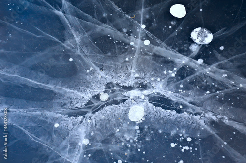 cracked ice texture, abstract seasonal winter cold background, natural ice, broken ice on a lake © kichigin19