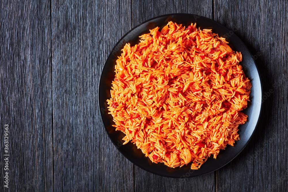 Tomato onion rice on a black plate Tomato onion rice on a black plate
