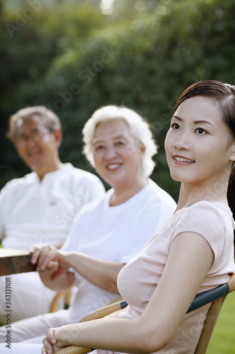 Woman with senior couple in the park