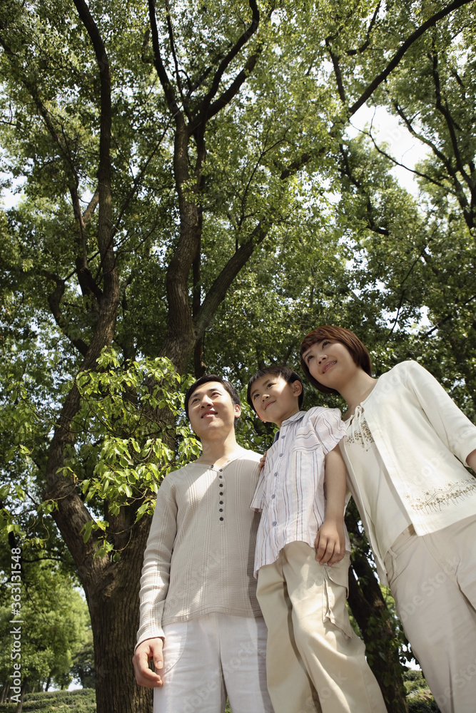 Boy and parents smiling while looking away Boy and parents smiling while looking away
