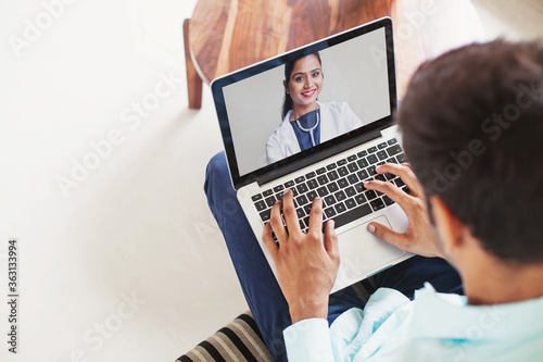 Man using his laptop to get medical consultation online from Indian doctor