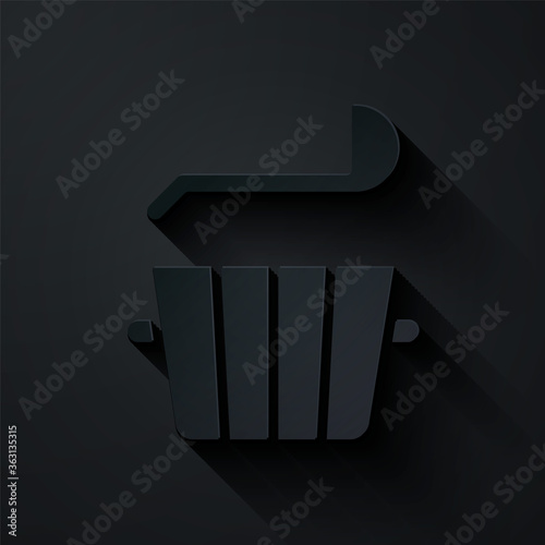 Paper cut Sauna bucket and ladle icon isolated on black background. Paper art style. Vector.