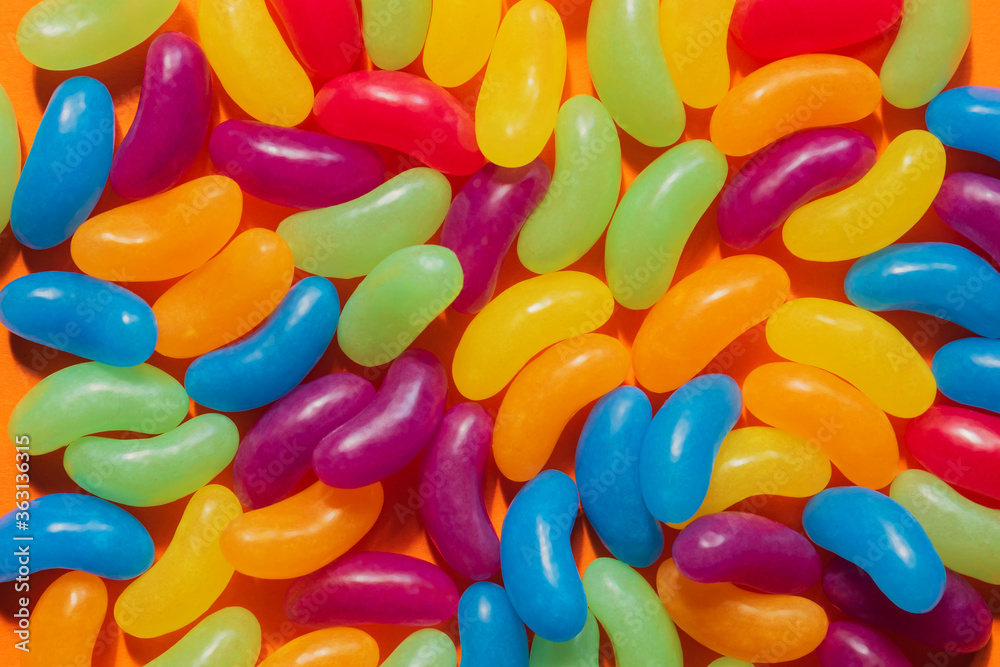 Assorted Jelly Beans border with copyspace on orange background Assorted Jelly Beans border with copyspace on orange background