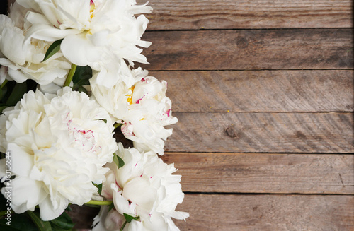 Fototapeta Naklejka Na Ścianę i Meble -  beautiful blooming white peonies on a wooden background with a copy space