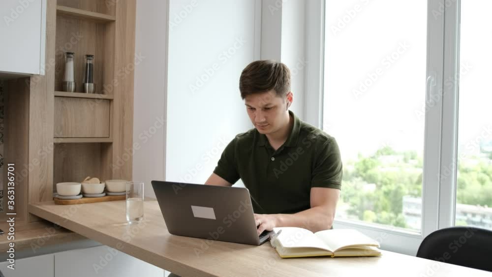 Businessman work at the computer at home in the morning, write an mail to his partners Businessman work at the computer at home in the morning, write an mail to his partners