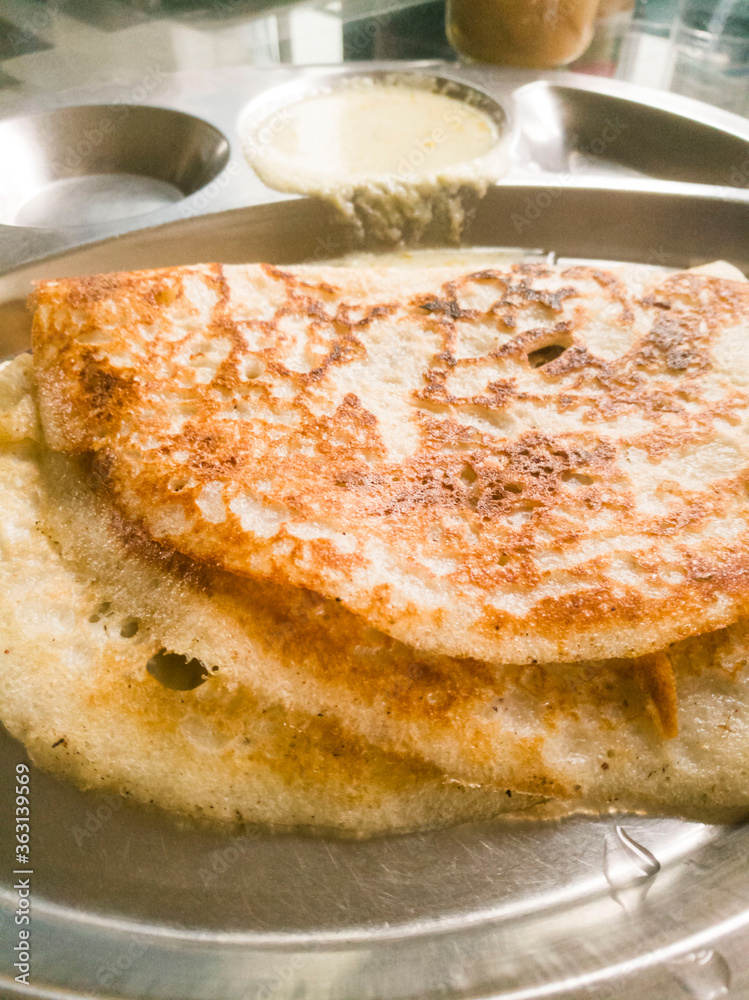 Home made dosa in a steel plate. Home made dosa in a steel plate.