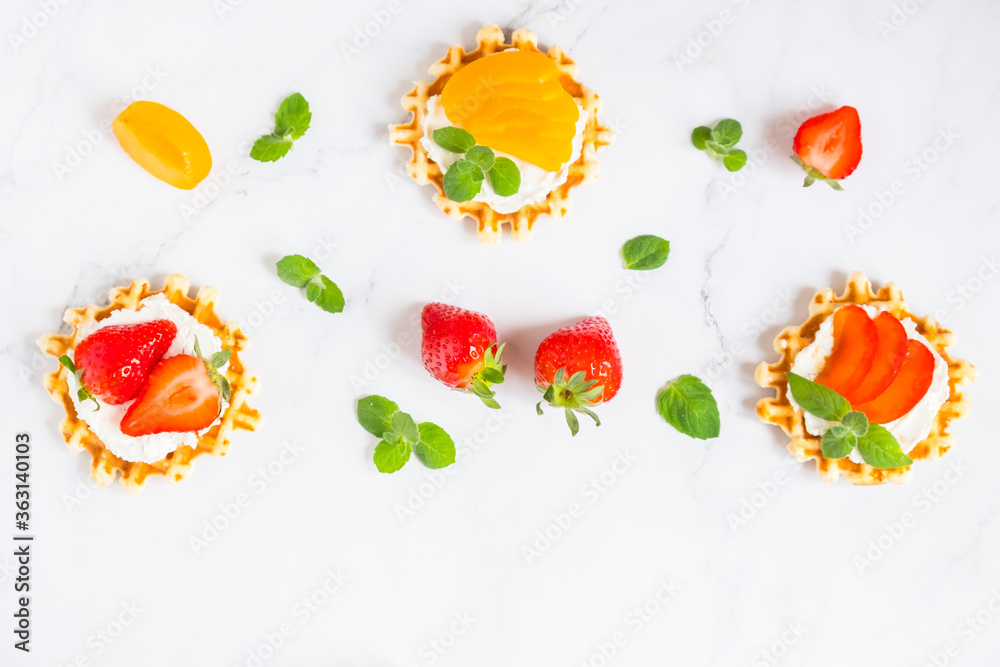 Top view of traditional Belgian waffles with soft cheese, fruits and berries with copy space. flat lay. Top view of traditional Belgian waffles with soft cheese, fruits and berries with copy space. flat lay.