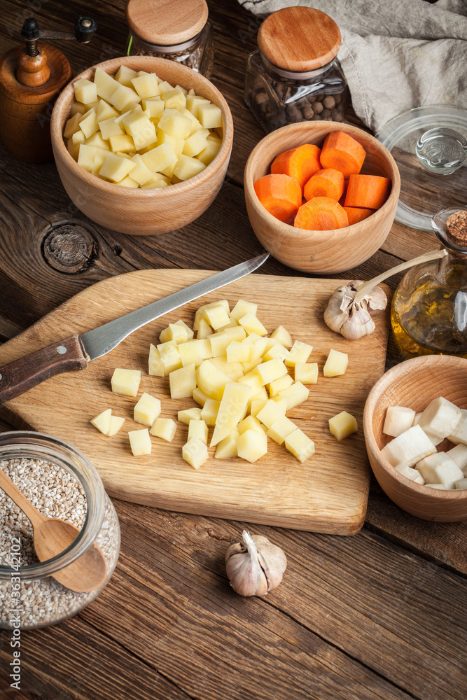 Diced potatoes on a wooden chopping board. Diced potatoes on a wooden chopping board.
