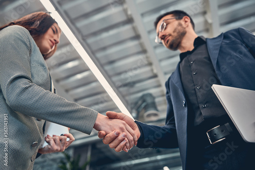 Photography Two business colleague shaking hand during meeting