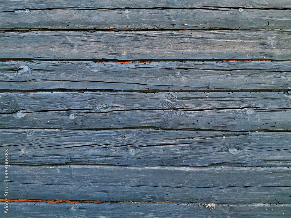 Old wooden wall painted black. Background of an old wooden wall. Old wooden wall painted black. Background of an old wooden wall.