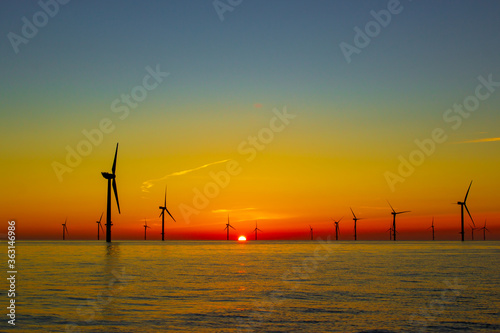 Fototapeta Naklejka Na Ścianę i Meble -  Beautiful sunset at the North Sea offshore wind farm