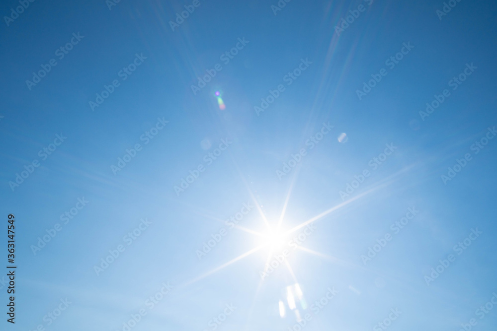 Sunbeams in the blue sky. Natural phenomenon. The nearest star of our system, i.e. the sun. Sunbeams in the blue sky. Natural phenomenon. The nearest star of our system, i.e. the sun.