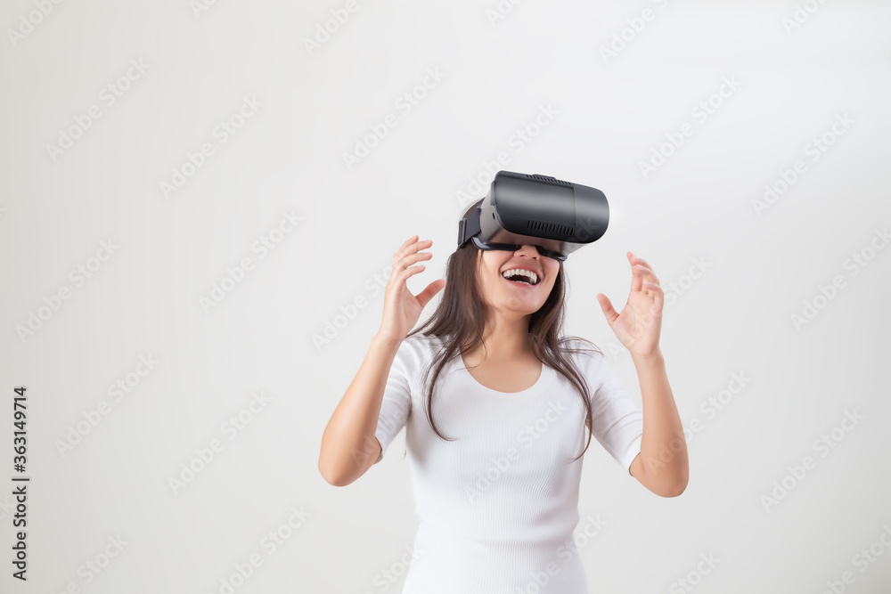 Young asian woman using VR device or virtual reality glasses. Excited about the new experience. Young asian woman using VR device or virtual reality glasses. Excited about the new experience.