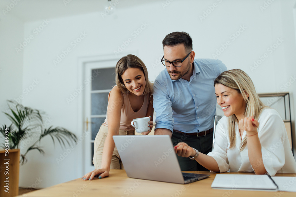 Friendly colleagues looking at laptop on a work break, portrait. Friendly colleagues looking at laptop on a work break, portrait.