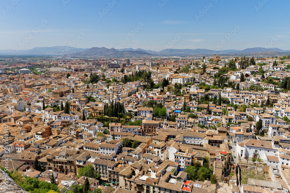 Aerial view of the city Granada from fortress Alhambra, Andalusia, Spain. With mountain range in background
