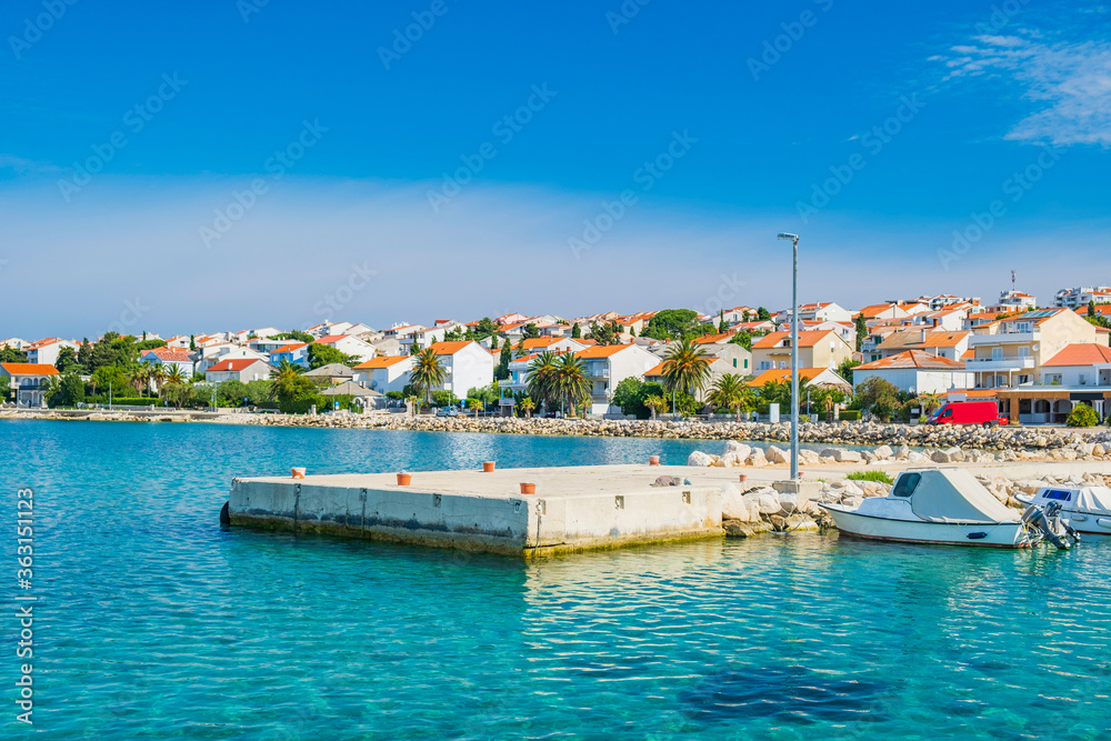 Croatia, town of Novalja on the island of Pag, boats in marina and turquoise sea in foreground