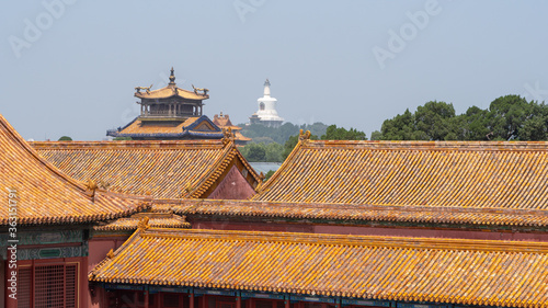  Forbidden City close to Tiananmen Square, the large square near the center of Beijing, Gate of Heavenly Peace. Eaves of traditional oriental ancient buildings.Panoramic view Beihai Park in background