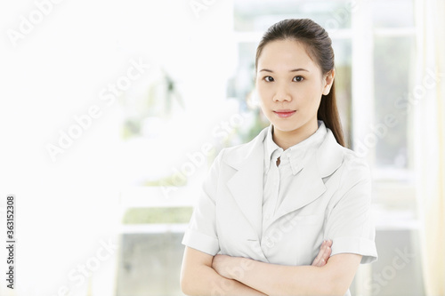 Female doctor smiling at the camera Free Download Female doctor smiling at the camera - GFXLoad