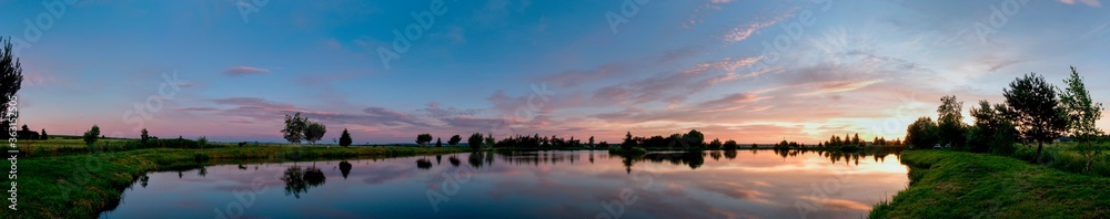 panorama of a beautiful sunrise on a summer lake