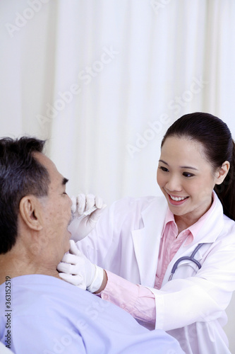 Doctor examining patient's temperature