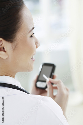 Female doctor using palmtop