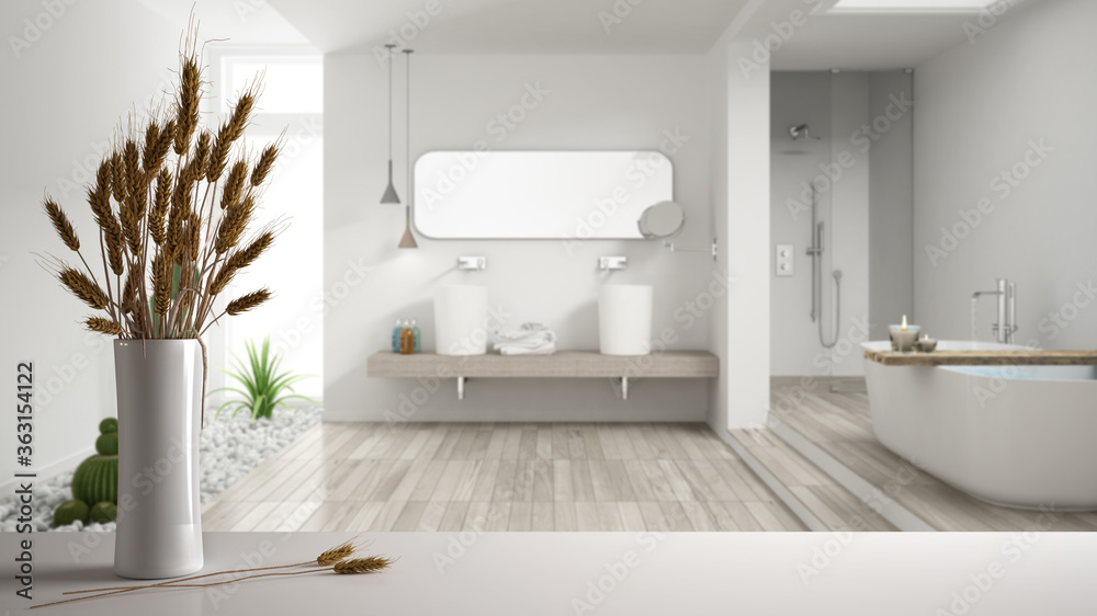 Fototapeta premium White table top or shelf with straws, dry plants, ornament, ears, sheaf, branch in vase, over white bathroom with bathtub, parquet and decors, modern minimal interior design