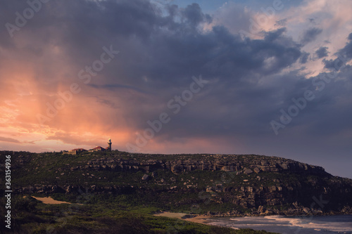 lighthouse in the mountain at sunset