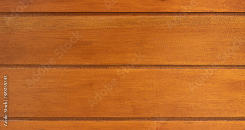 Wood made of orange glazed lined up in a row as an abstract backdrop.
