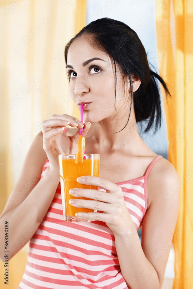 Woman enjoying a glass of orange juice Woman enjoying a glass of orange juice