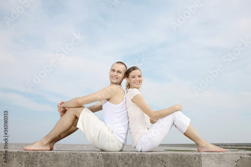 Man and woman sitting back to back