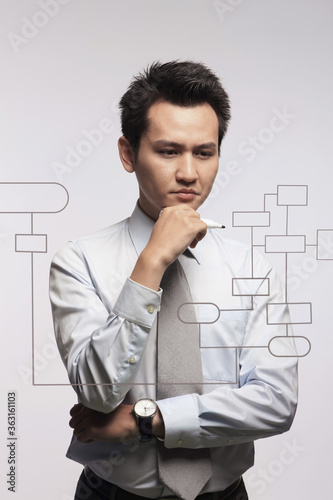 Businessman looking at diagram on touch screen interface