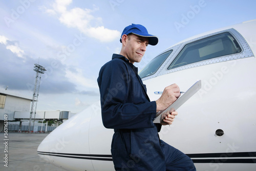 Mechanic examining private jet