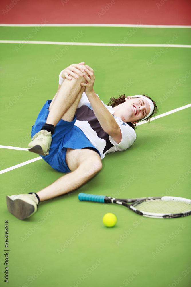 Fototapeta premium Man with knee injury while playing tennis