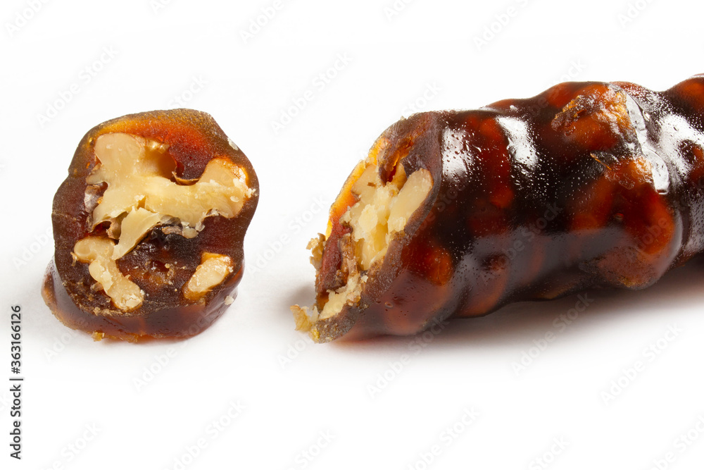 Walnuts on a string dipped in starch grape molasses. Churchkhela. Walnut sujuk. Walnuts on a string dipped in starch grape molasses. Churchkhela. Walnut sujuk.