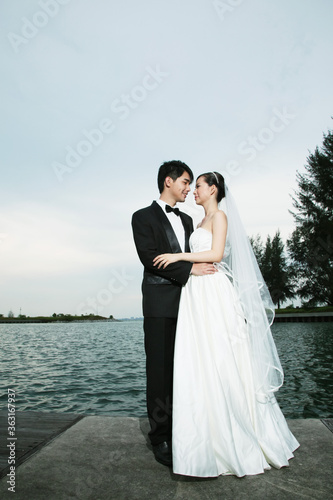 Bride and groom posing outdoors © ImageHit
