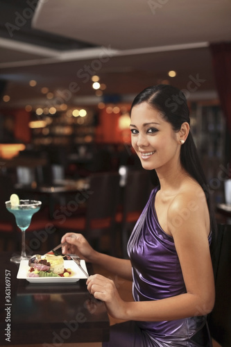 Woman eating in a restaurant