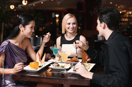 Man and women having dinner together