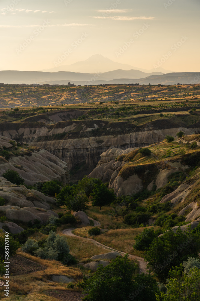 Landscape of Goreme ancient town in a morning sunrise. Cappadocia plateau in middle of Anatolia region in Turkey