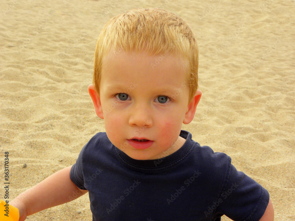 Portrait of a blond boy with a surprised look and wide eyes. Charming three year old boy looking directly at the camera and smiling. Happy baby Portrait of a blond boy with a surprised look and wide eyes. Charming three year old boy looking directly at the camera and smiling. Happy baby
