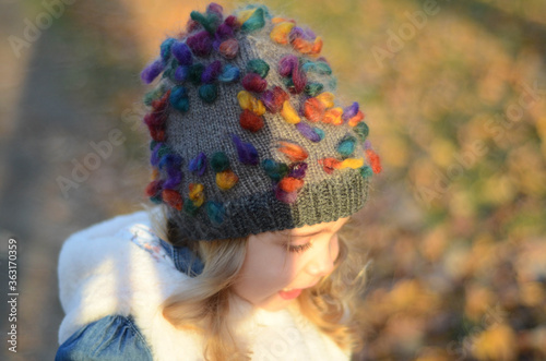 Picture of a blonde toddler girl in the funny knitted hat